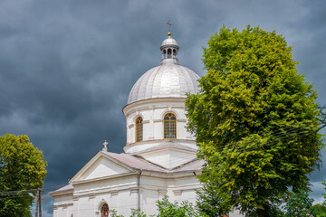 Former brick Greek Catholic church in Werchrata, erected in 1910. The dramatic sky in the background