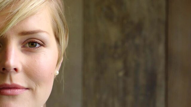 Closeup portrait of a young woman looking carefree and calm while standing alone. Half and side of a females face looking serious. Life insurance and medical healthcare are important for everybody