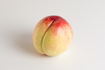 One ripe juicy nectarine. Ripe juicy bald peach on a white background. Isolated