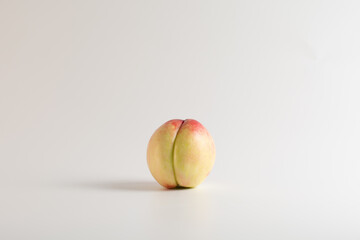 One ripe juicy nectarine. Ripe juicy bald peach on a white background. Isolated