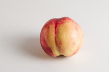 Ripe juicy nectarine. Ripe juicy bald peach on a white background. Isolated