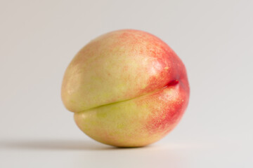 Ripe juicy nectarine. Ripe juicy bald peach on a white background. Isolated