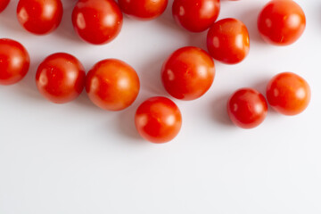 Fresh tasty red cherry tomatoes on white background