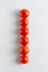 Number one. A figure of cherry tomatoes on a white background. Tomatoes close-up. Tomatoes in the form of the Number one