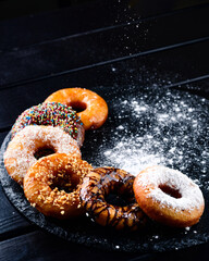 set of donuts on a black table with a copy space