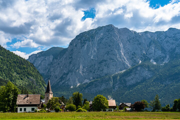Beautiful idyllic panorama view of Altaussee town with the peak Trisselwand in background on a sunny summer day with blue sky cloud, Salzkammergut-Ausseerland region, Styria, Austria - 517322183