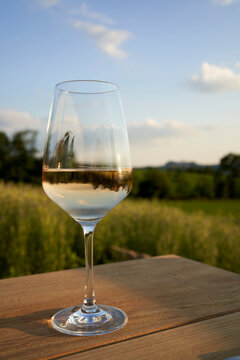 Glass of white wine on the table outdoors