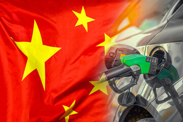 Car with a fuel injector on China flag background. Record prices fuel for population. Gasoline...