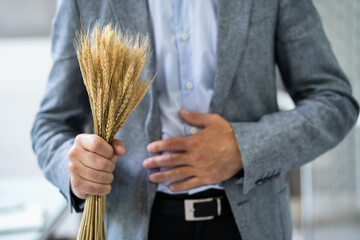 Celiac Disease And Gluten Intolerance. Women Holding Spikelet