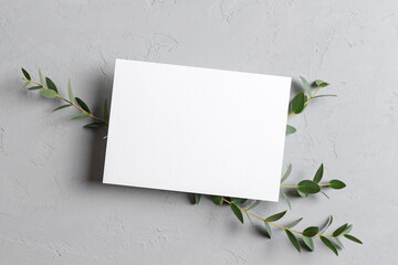 Wedding invitation or greeting card mockup with natural eucalyptus twigs