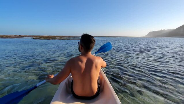 Indonesian Man Canoeing Canoe at Gunung Payung Beach, Bali, Indonesia