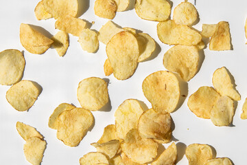 Chips are scattered on a white background. Top view, flat lay