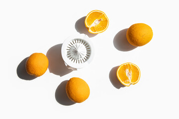 Fresh oranges prepared for juicing in a hand bowl on a white background. Top view, flat lay
