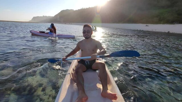 Indonesian Man Canoeing Canoe at Gunung Payung Beach, Bali, Indonesia