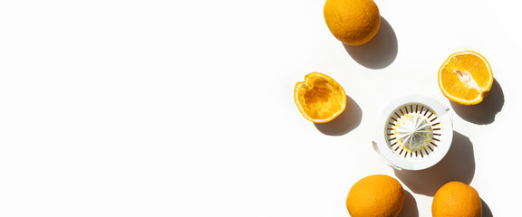 Oranges and hand bowl for making fresh juice on a white background. Top view, flat lay. Banner