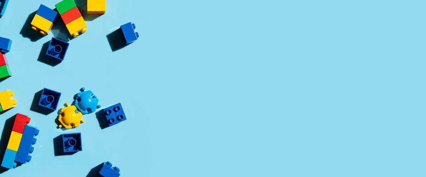 Constructor children's plastic multi-colored on a blue background. Top view, flat lay. Banner