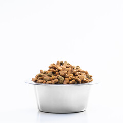 Round metal bowl for pets with dry food. Isolated on white background. View from above. Full plate with a slide