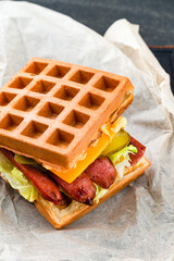 Waffle waffles with grilled sausages and fresh vegetables