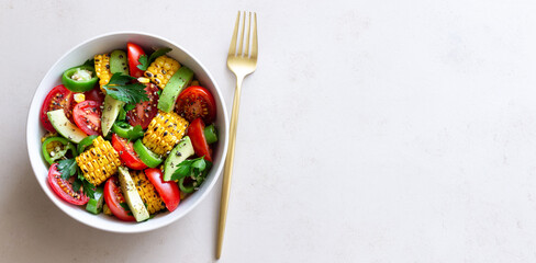 Salad with corn, avocado, tomatoes, peppers and parsley. Healthy eating. Vegetarian food.