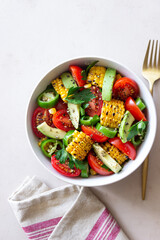 Salad with corn, avocado, tomatoes, peppers and parsley. Healthy eating. Vegetarian food.