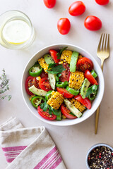 Salad with corn, avocado, tomatoes, peppers and parsley. Healthy eating. Vegetarian food.