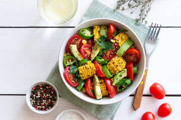 Salad with corn, avocado, tomatoes, peppers and parsley. Healthy eating. Vegetarian food.