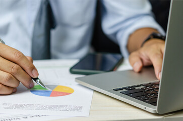 businessman data document graph chart report marketing research development working at office with laptop.