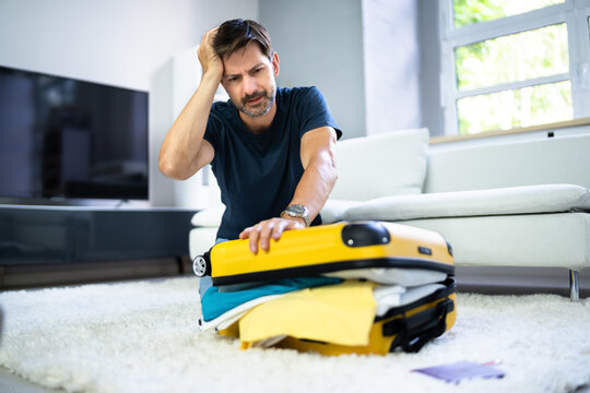 Man Packing Stuffed Suitcase Bag