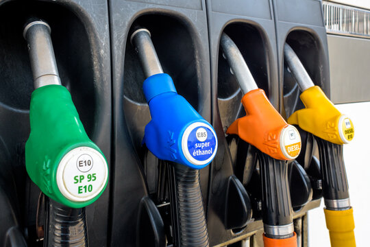 France - June 19, 2022: Close-up view of a four nozzle fuel pump at a gas station dispensing B10 Diesel (yellow), B7 Diesel (orange), E85 "super ethanol" petrol (blue) and E10 petrol (green).