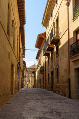 Fototapeta na wymiar Cobblestoned street in the medieval town of Briones, Rioja, Spain. Picturesque And Narrow Streets On A Sunny Day. Architecture, Art, History, Travel