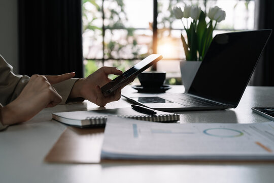 Modern workplace cloae up businesswoman using mobile phone in office.