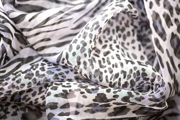 Satin fabric close up background and texture with place for text. Gray leopard print chiffon or...