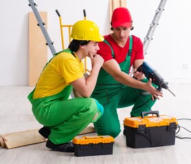 Two workers contractors working indoors