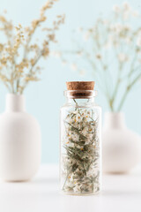 Dried herbal flowers with bottle. Homeopathy background.