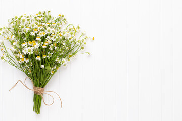 Chamomile flowers floral framee. Flat lay, top view.