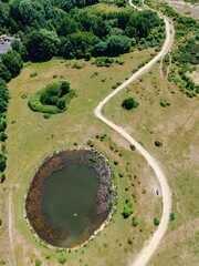 Aerial view of a pond created from the void left by removing fuel storage wells at ex RAF Greenham...