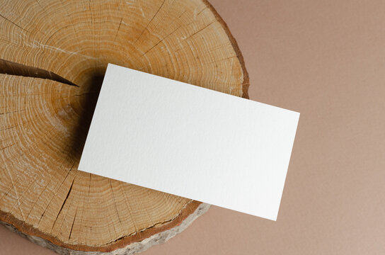 Blank business card mockup on wooden background