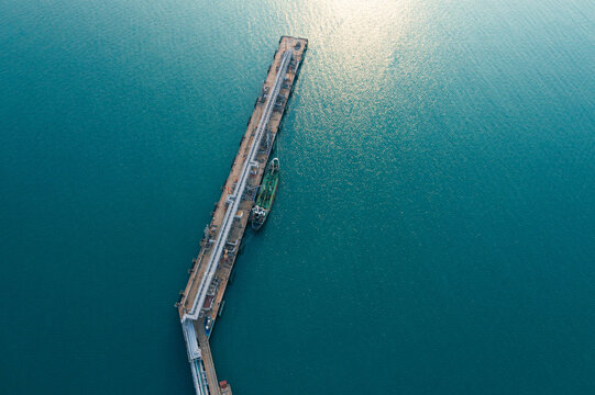 Aerial view of Modern logistic sea harbor with transshipment equipment for Crude oil tanker or Gas LPG tanker container ship. Oil tanker ship to Port of Europe - import export