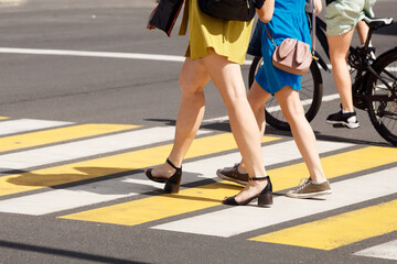 people crossing the road at a pedestrian crossing