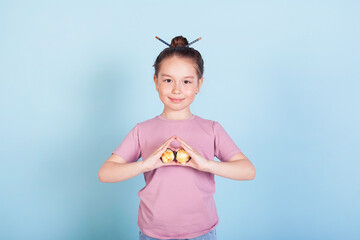 Cute smiling little girl with with sushi on red background. Student child girl eating sushi and...