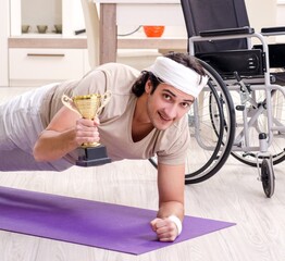 Injured young man doing exercises at home