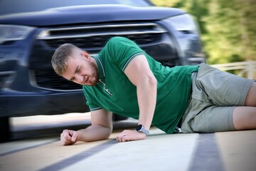Young downed man at accident scene, crash on the road on crosswalk. Pedestrian guy hit by careless...