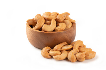 Roasted cashew nuts in wooden bowl on white background.