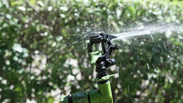 Close-up device for artificial watering of greenery or fields. Artificial irrigation of plants. Device for watering.