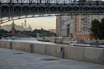Bridge, Moskva River with pleasure boats, towers of the Moscow Kremlin and orthodox temple.