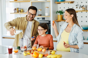 woman pregnant food healthy juice fruit kitchen family child fresh diet mother preparing blender drink pregnancy father daughter home bonding