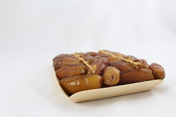 Cardboard tray of date fruits on grey background