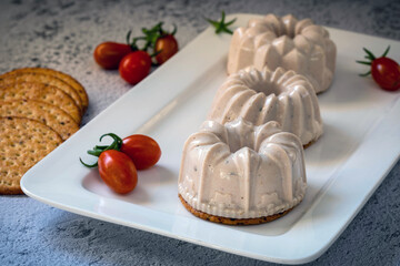 Portioned tuna mousse on a cracker.