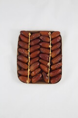 Cardboard tray of date fruits on grey background
