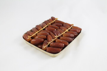 Cardboard tray of date fruits on grey background